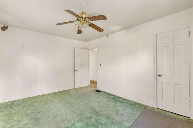 empty room with baseboards, ceiling fan, and carpet floors