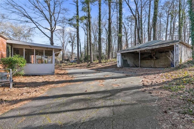 exterior space featuring a sunroom and driveway