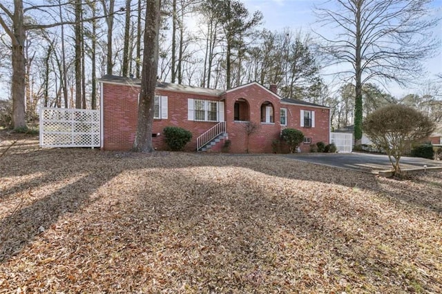 ranch-style home with crawl space, brick siding, and a chimney