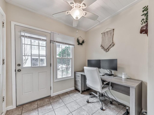 office space with light tile patterned flooring, ceiling fan, and baseboards