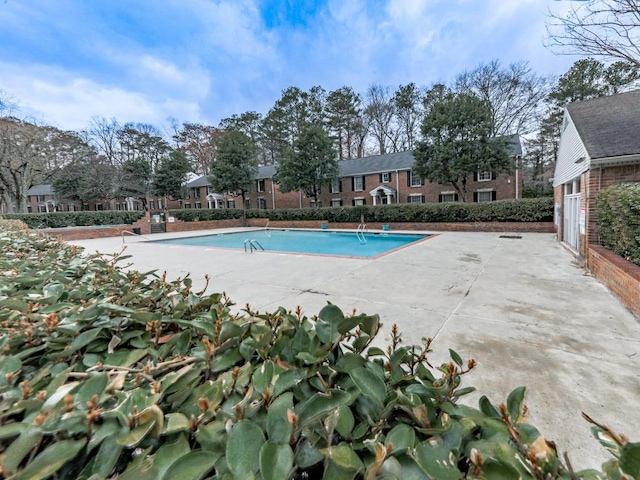 community pool with a patio area