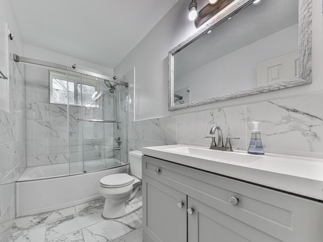 full bath featuring marble finish floor, tile walls, toilet, enclosed tub / shower combo, and vanity