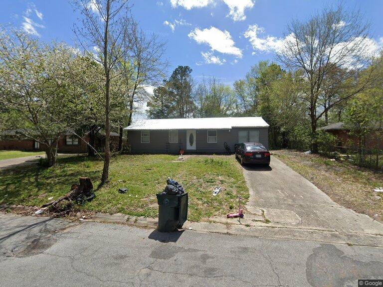 ranch-style home with a front lawn