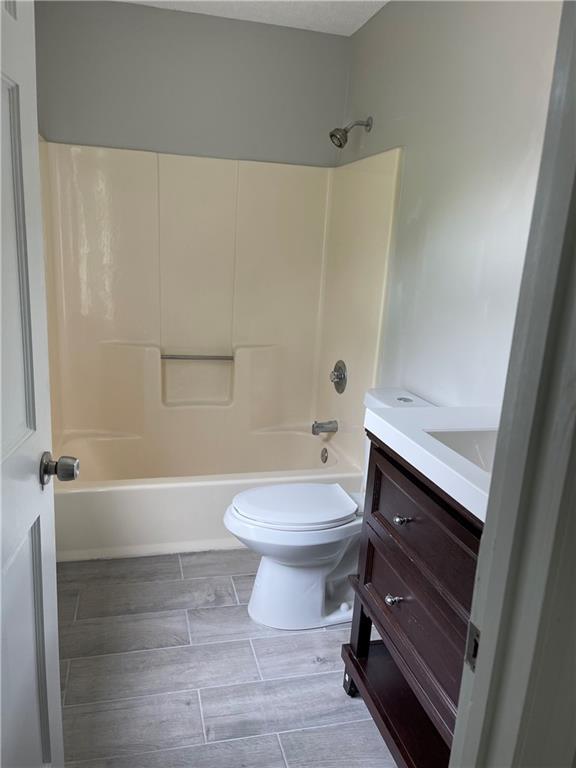 full bathroom with vanity, toilet, and bathtub / shower combination