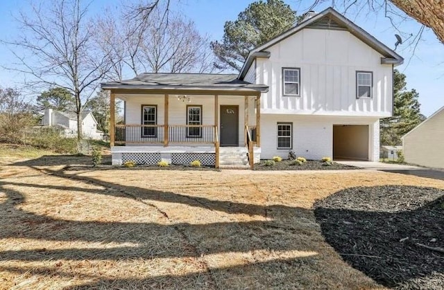 1382 Bennett Rd, Grayson, GA 30017 - tri-level home featuring a porch, board and batten siding, an attached garage, brick siding, and driveway