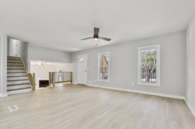 1382 Bennett Rd, Grayson, GA 30017 - unfurnished living room featuring stairway, wood finished floors, a ceiling fan, and baseboards