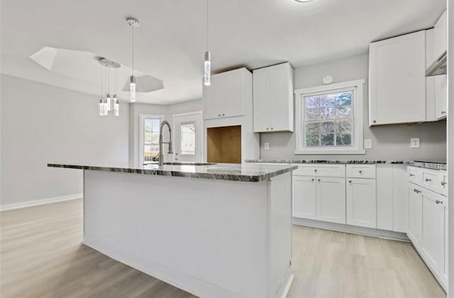 1382 Bennett Rd, Grayson, GA 30017 - kitchen featuring light wood-style floors, a kitchen island with sink, and plenty of natural light