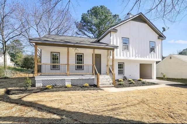 1382 Bennett Rd, Grayson, GA 30017 - split level home with a porch, board and batten siding, an attached garage, a chimney, and brick siding