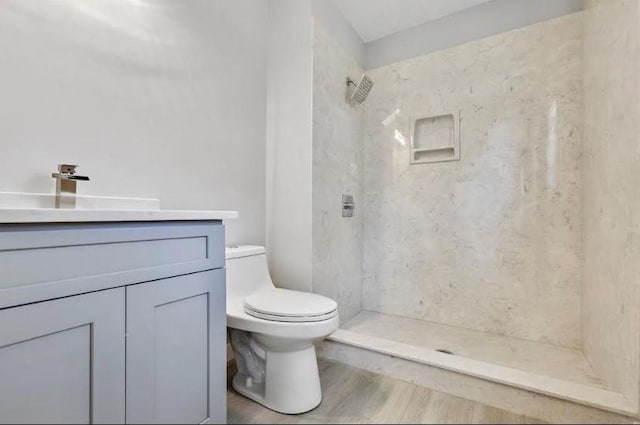 1382 Bennett Rd, Grayson, GA 30017 - full bathroom featuring toilet, vanity, tiled shower, and wood finished floors