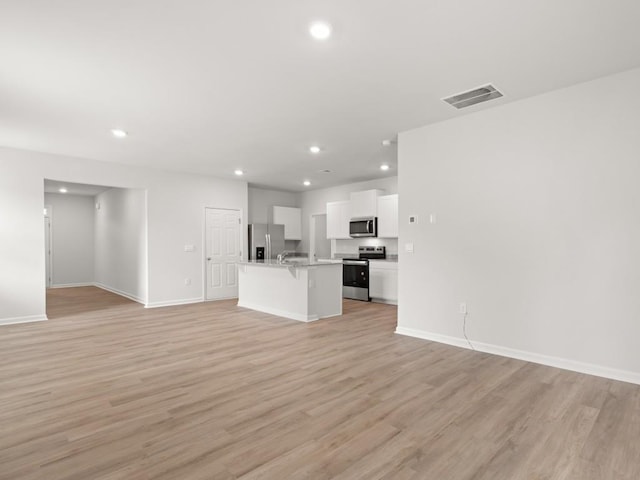 885 Lost Creek Blvd, Dallas, GA 30132 - unfurnished living room with recessed lighting and light wood-style flooring