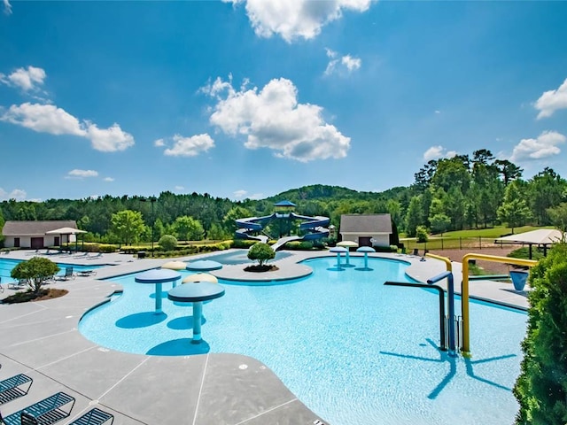 885 Lost Creek Blvd, Dallas, GA 30132 - community pool with a water play area, a patio, and a wooded view