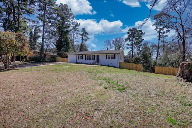 exterior space with a front lawn and fence