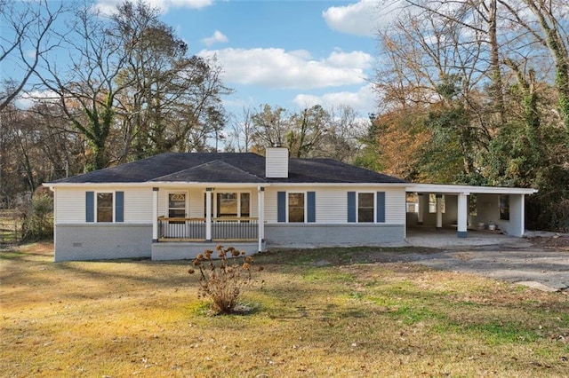 ranch-style home with covered porch, a chimney, and a front yard