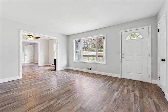 entryway featuring a ceiling fan, baseboards, visible vents, and wood finished floors