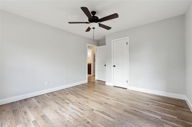 unfurnished bedroom featuring a ceiling fan, a closet, baseboards, and light wood finished floors