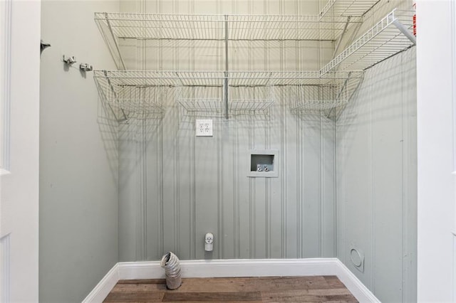 laundry area with laundry area, baseboards, washer hookup, and wood finished floors