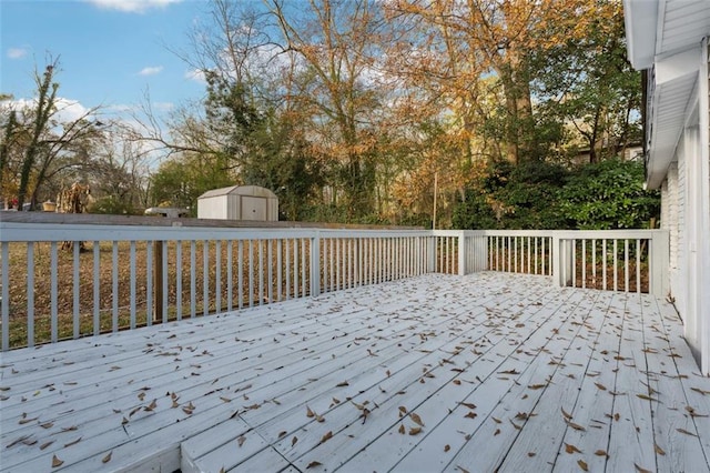 wooden deck featuring a storage unit and an outdoor structure