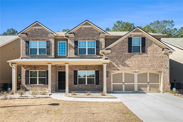 view of front of home with cooling unit, concrete driveway, and brick siding