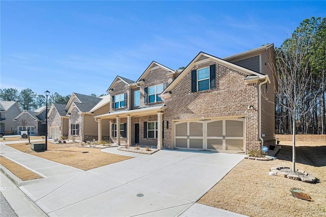 view of front of property featuring covered porch, brick siding, driveway, and an attached garage