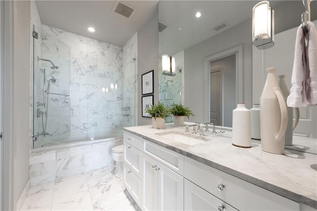 full bathroom with tiled shower / bath combo, vanity, and toilet