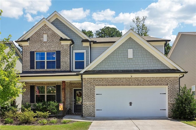 craftsman inspired home featuring covered porch and a garage