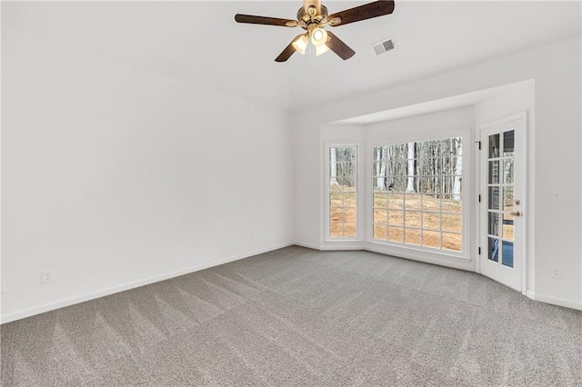 carpeted empty room featuring ceiling fan