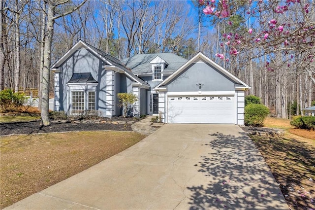 view of front of house featuring a garage and a front lawn