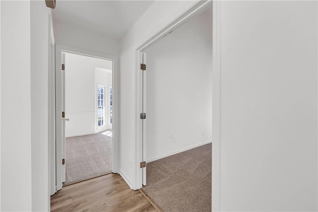 hallway with light wood-type flooring