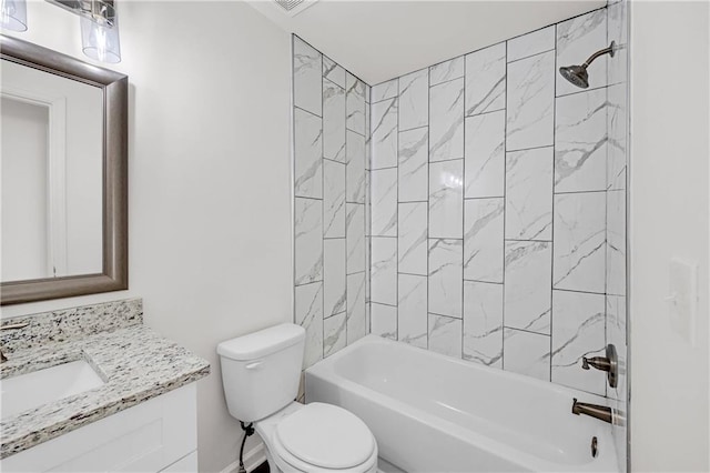 full bathroom with vanity, tiled shower / bath combo, and toilet