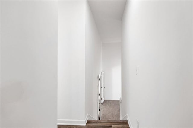 hallway with dark hardwood / wood-style flooring