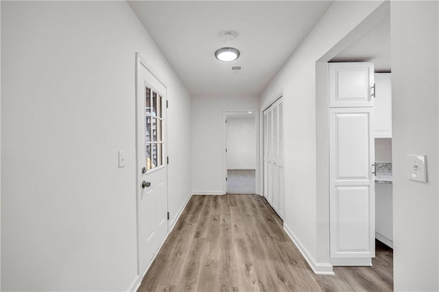 corridor with light wood-type flooring