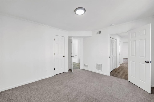 unfurnished bedroom featuring carpet floors and ornamental molding