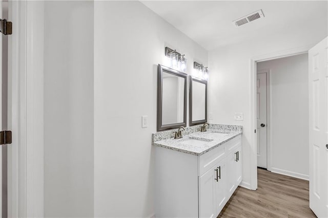 bathroom with hardwood / wood-style flooring and vanity