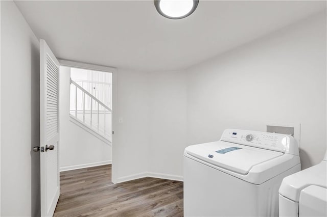 laundry room featuring wood-type flooring and washing machine and dryer