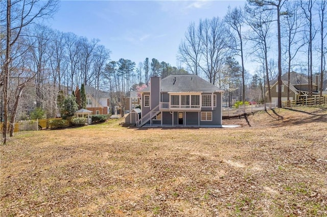 back of house with a lawn and a deck