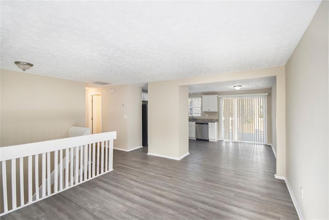 unfurnished room with a textured ceiling and hardwood / wood-style floors