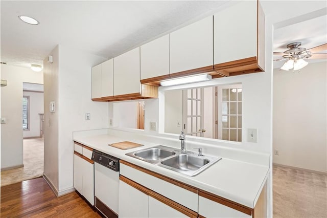 kitchen with ceiling fan, light countertops, white cabinets, a sink, and dishwasher