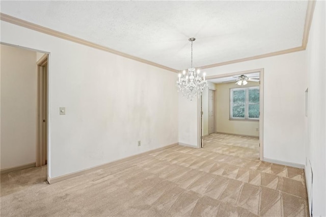spare room with baseboards, ornamental molding, ceiling fan with notable chandelier, and light carpet