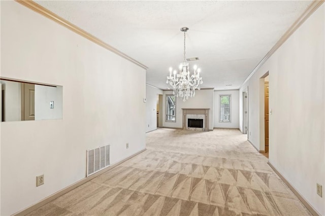 unfurnished living room featuring visible vents, crown molding, carpet floors, and an inviting chandelier