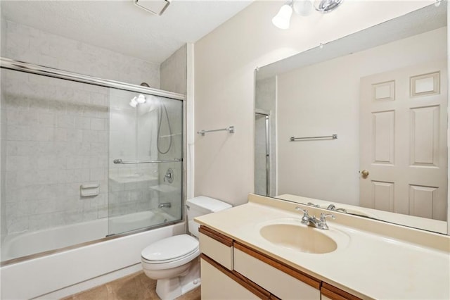 full bathroom with toilet, combined bath / shower with glass door, tile patterned flooring, and vanity