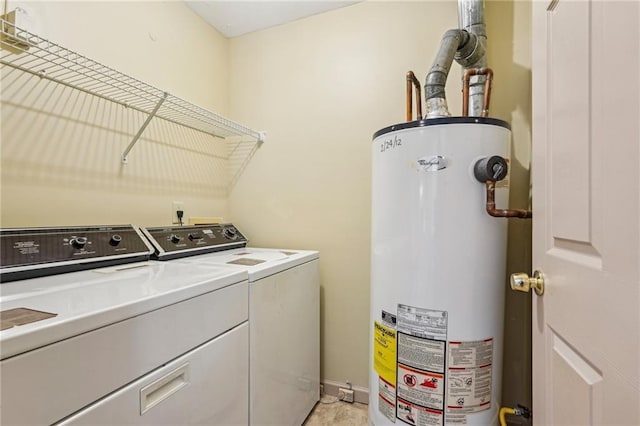 washroom with washer and dryer, laundry area, and water heater
