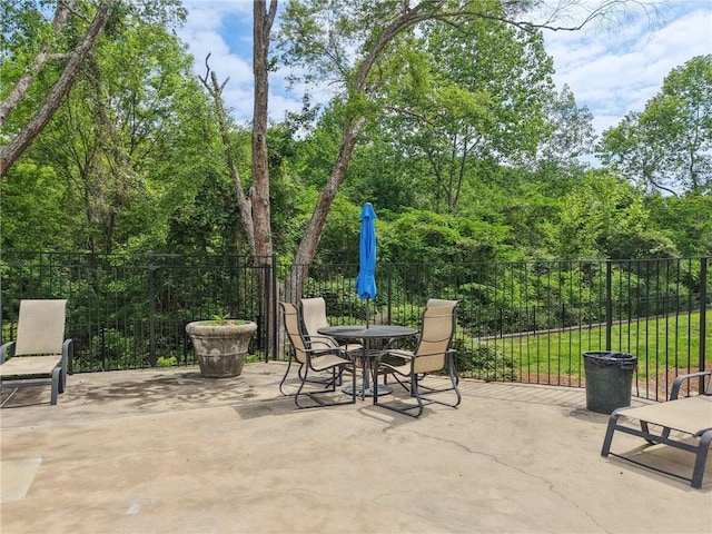 view of patio featuring fence and outdoor dining space