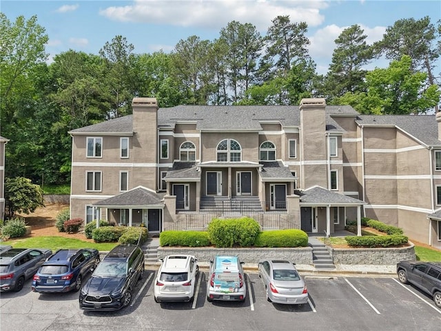 view of building exterior featuring uncovered parking