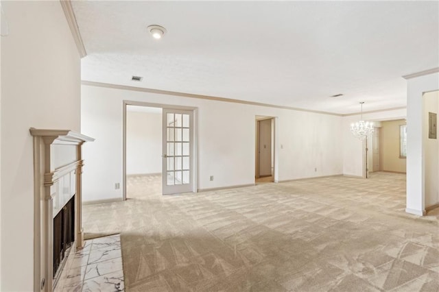unfurnished living room featuring ornamental molding, a fireplace with flush hearth, a notable chandelier, and light carpet