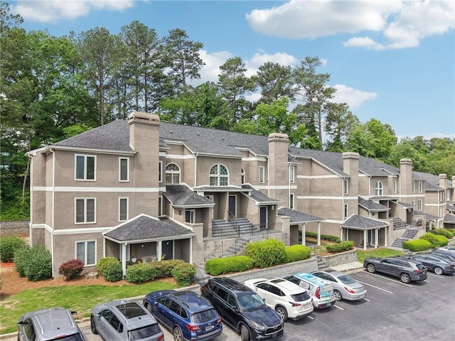 view of property featuring a residential view and uncovered parking