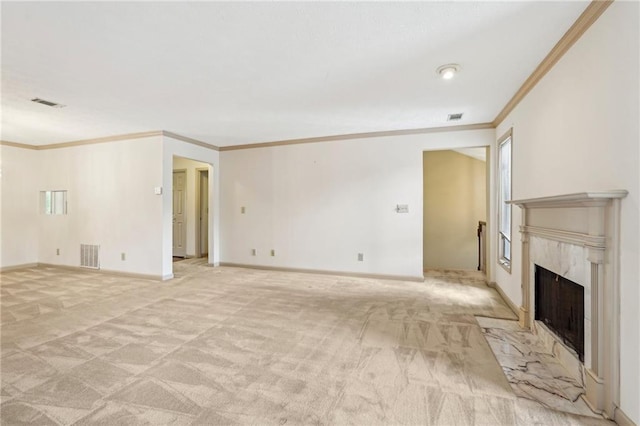 unfurnished living room featuring crown molding, a high end fireplace, light colored carpet, and visible vents