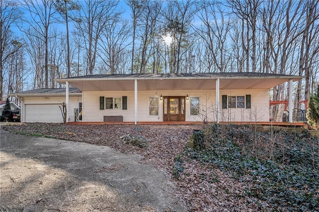 view of front of home featuring a porch and a garage