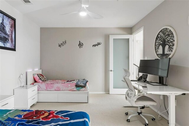 bedroom featuring light colored carpet and ceiling fan