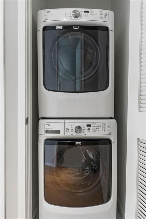 clothes washing area with stacked washer / drying machine