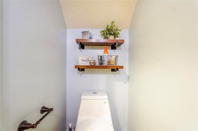 bathroom with a textured ceiling and toilet